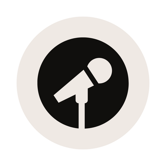 A white circle with a black microphone icon in the center, symbolizing audio recording or broadcasting