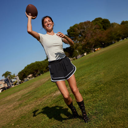 Conscious Step: Socks that Support Youth Sports (Black Footballs)
