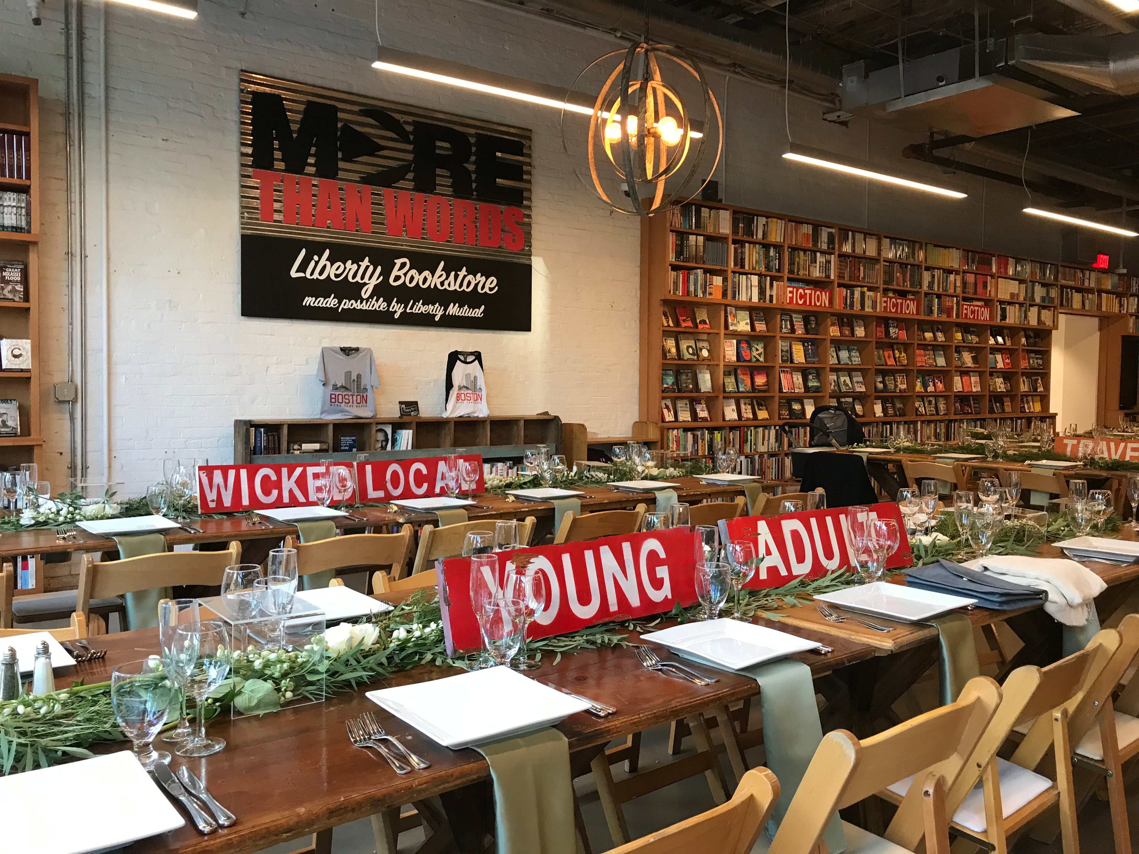 Two neatly arranged wedding tables placed in the middle of a library setting