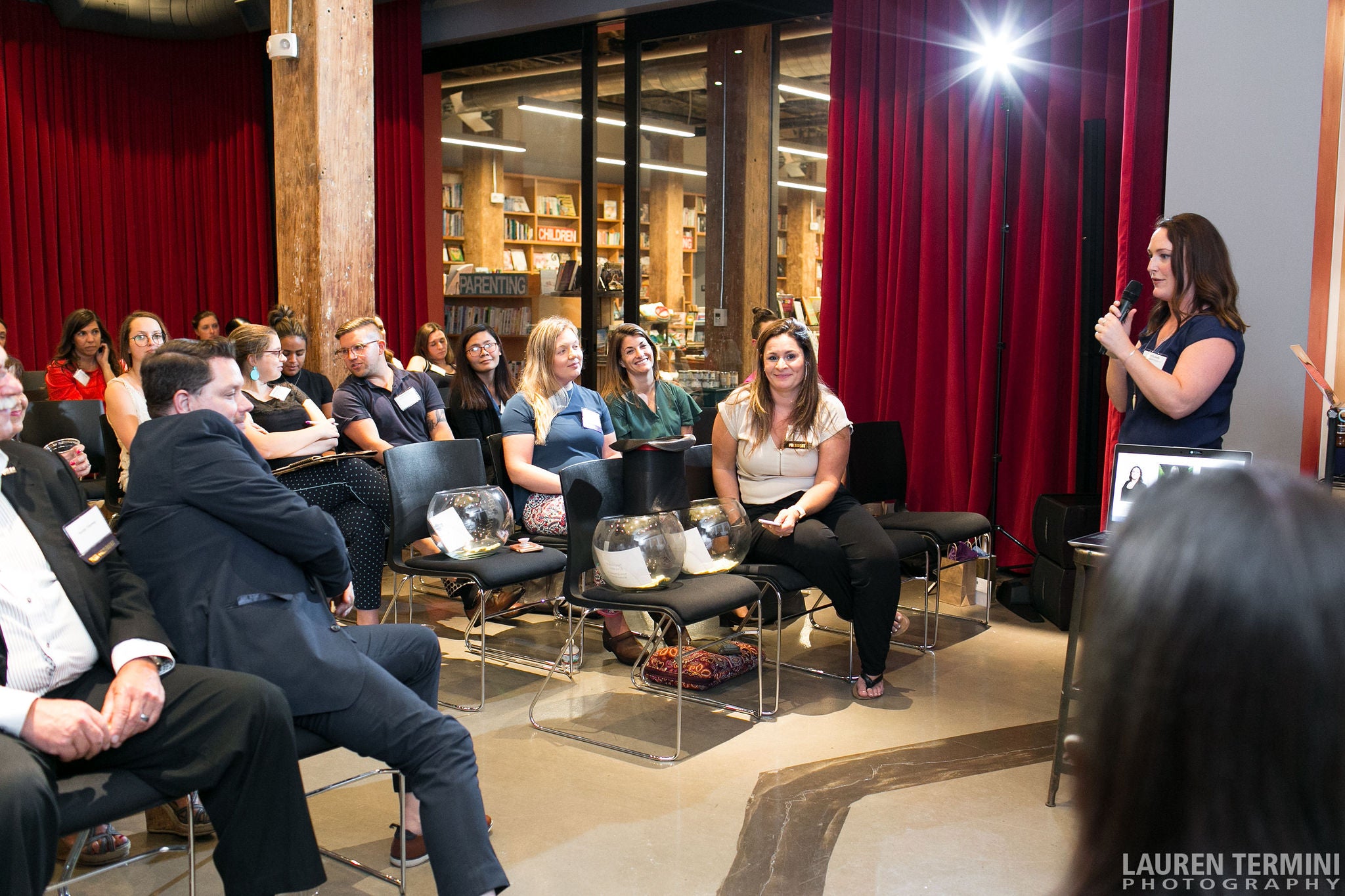 A female speaker engaging a group of individuals with a captivating presentation in a corporate setting