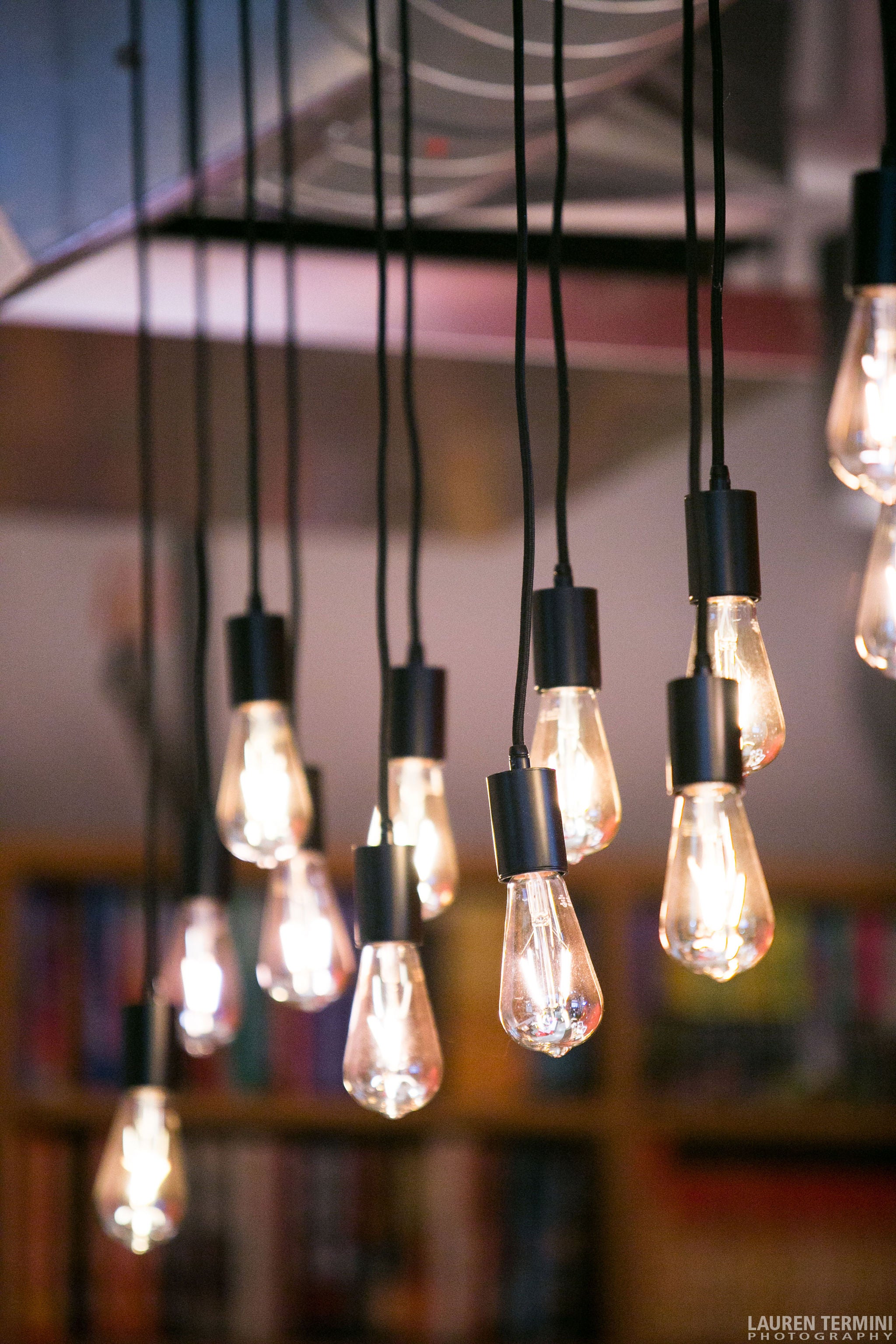 A cluster of suspended light bulbs illuminating the room from the ceiling